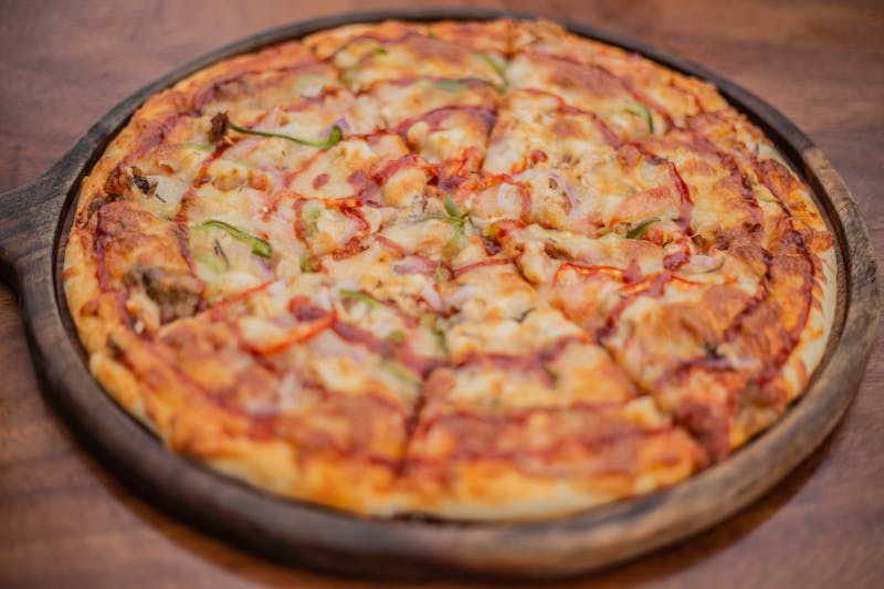 Close-up of a dions pizza slice with fresh toppings